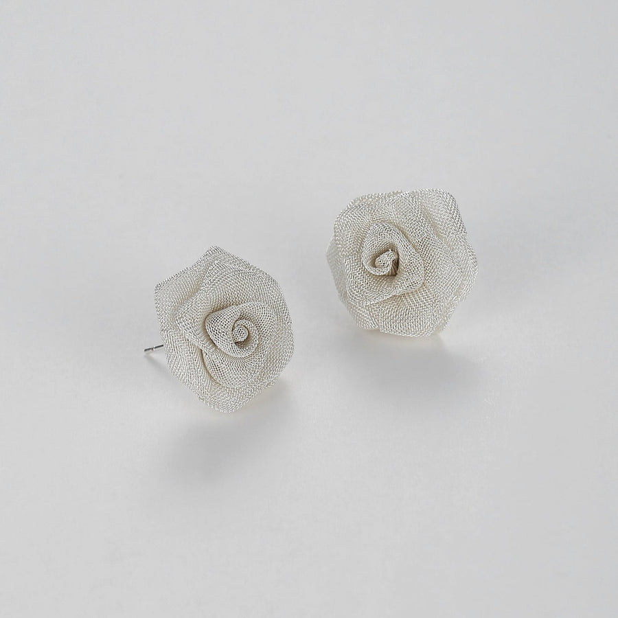 Meticulously crafted from fine metallic mesh, these studs bloom into stunning roses that exude sophistication and charm. Perfect for both daywear and evening ensembles, these Mesh Rose Earrings are sure to add a touch of refined grace to any outfit. 