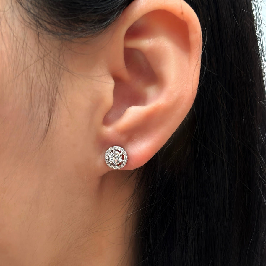 925 silver earrings. These dazzling stud earrings feature a brilliant round-cut centerpiece surrounded by a halo of sparkling cubic zirconia. Perfectly crafted in a sleek silver-tone finish, they exude timeless elegance for any occasion.