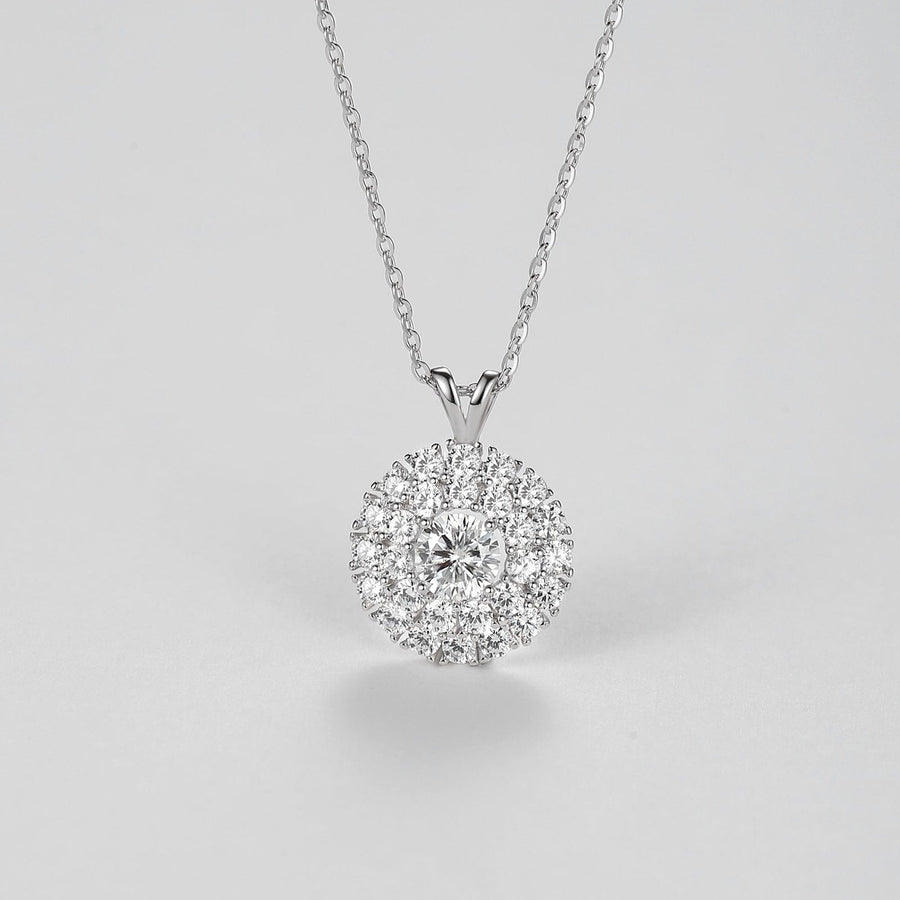 The centerpiece features a 0.5 carat Moissanite, renowned for its exceptional sparkle and clarity, surrounded by a halo of smaller stones that enhance its radiance. The delicate silver chain complements the pendant perfectly, making it a versatile piece suitable for both everyday wear and special occasions. Whether as a gift or a personal indulgence, this necklace is sure to become a cherished favorite.