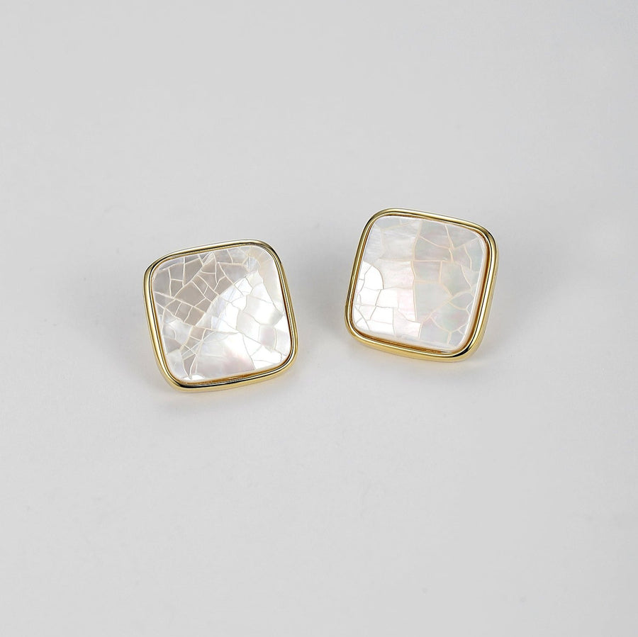 These exquisite studs showcase a lustrous mother-of-pearl centerpiece, beautifully framed in a polished gold-tone setting, adding a touch of timeless elegance to any look. Perfect for both everyday wear and special occasions, these earrings bring a subtle yet sophisticated shine to your jewelry collection.