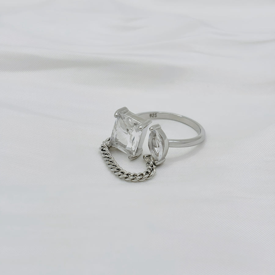 925 silver adjustable ring. This unique sterling silver ring features a bold geometric design with two sparkling gemstones connected by a delicate chain, embodying modern elegance. 