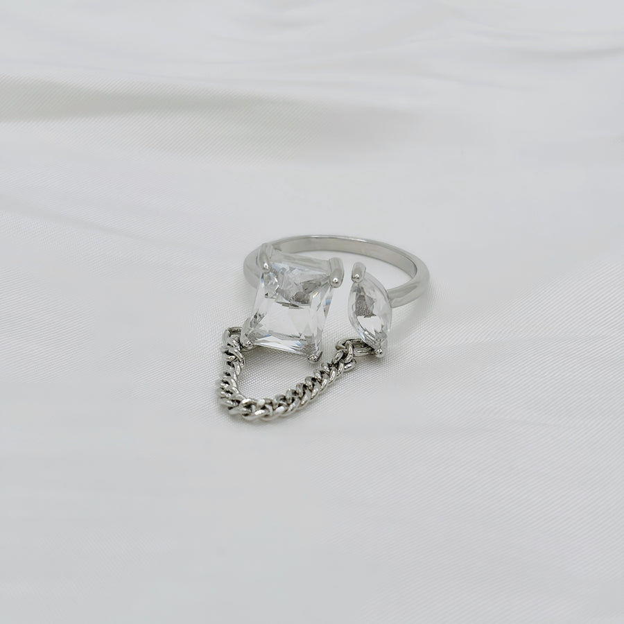 925 silver adjustable ring. This unique sterling silver ring features a bold geometric design with two sparkling gemstones connected by a delicate chain, embodying modern elegance. 