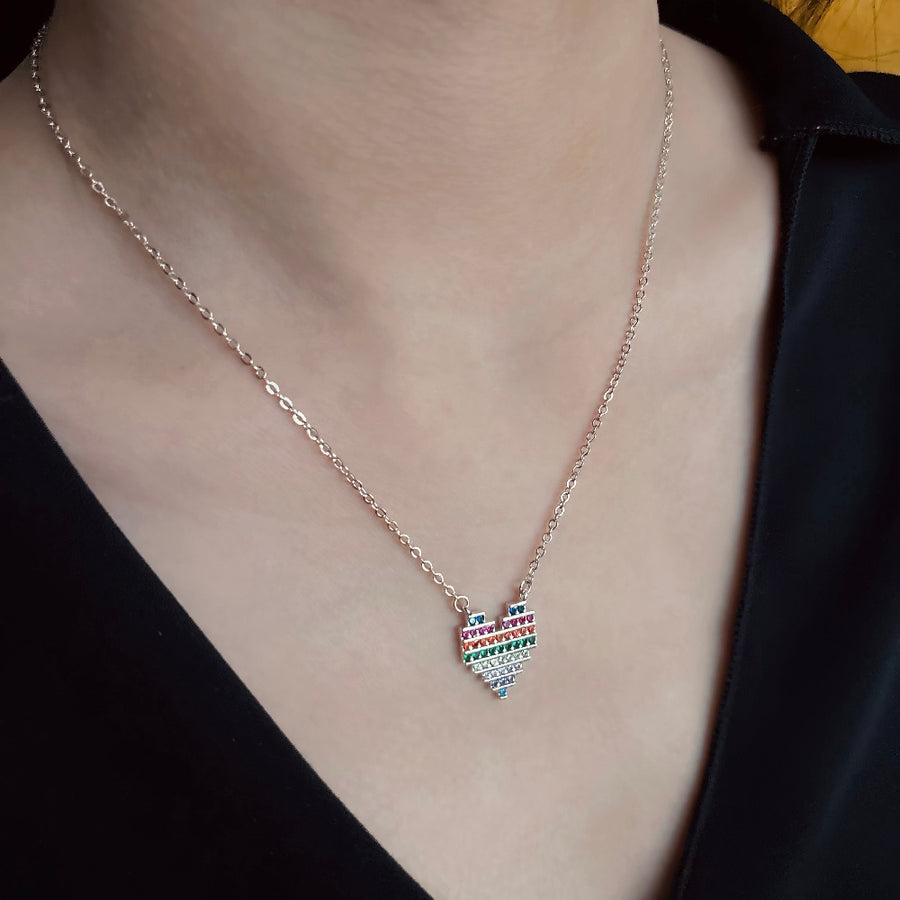 The 925 silver necklaces feature a rainbow heart-shaped pendant with colorful and vibrant cubic zirconia stones. The necklace can be beautifully layered for a stunning stacked effect that adds a burst of color and joy to your style.