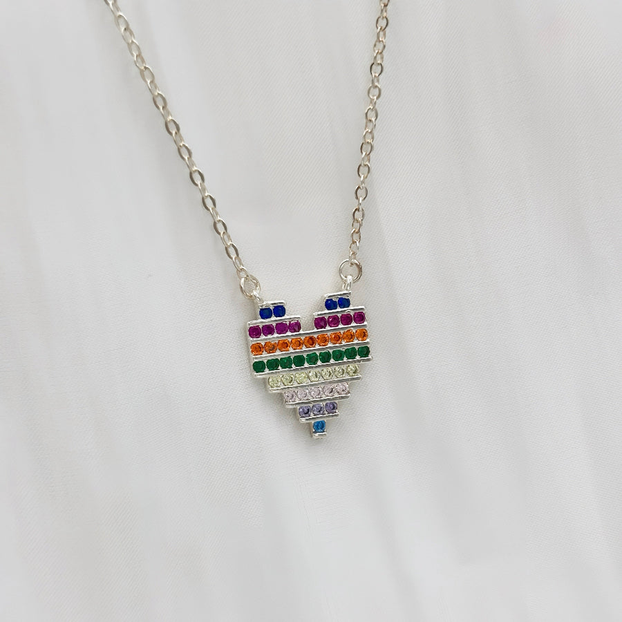 The 925 silver necklaces feature a rainbow heart-shaped pendant with colorful and vibrant cubic zirconia stones. The necklace can be beautifully layered for a stunning stacked effect that adds a burst of color and joy to your style.