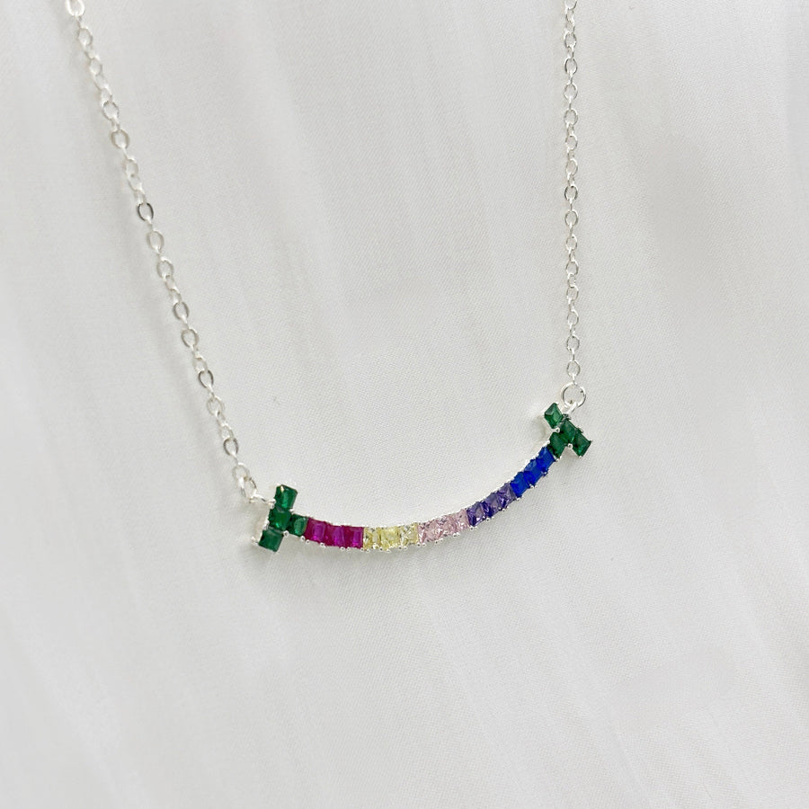 The 925 silver necklaces feature a rainbow smiling face-shaped adorned pendant with colorful and vibrant cubic zirconia stones. The necklace can be beautifully layered for a stunning stacked effect that adds a burst of color and joy to your style.