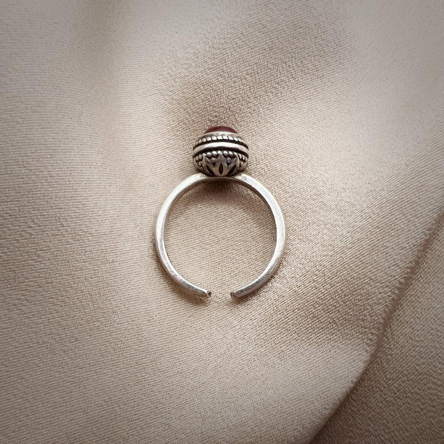 The adjustable vintage ring features a red stone that adds a touch of retro charm and elegance to any outfit. Handmade in 925 silver