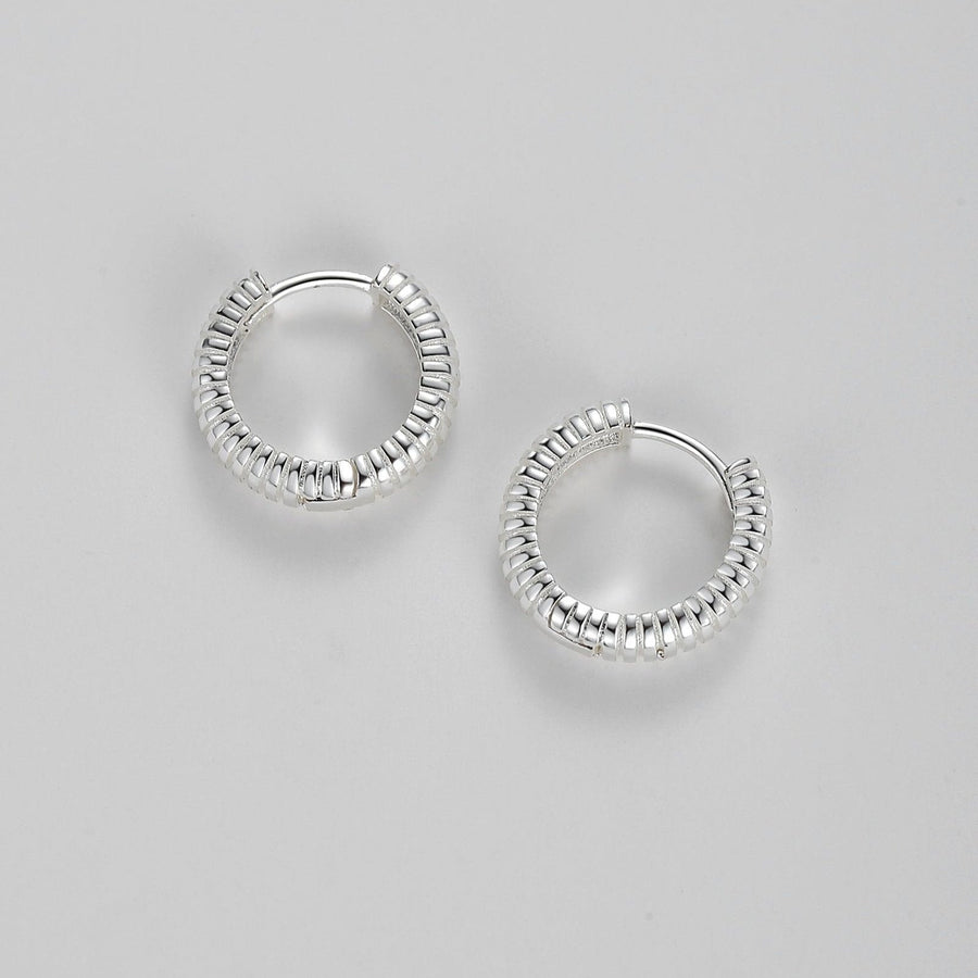 925 silver hoops. The unique ribbed detailing on these hoops catches the light at every turn, ensuring that you’ll sparkle from day to night. Whether dressing up for a special occasion or accentuating your everyday style, the hoops are an exquisite choice that exudes chic sophistication.