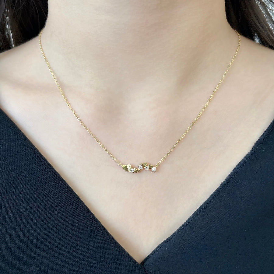 This elegant necklace features a delicate gold chain adorned with a series of small gold hearts interspersed with sparkling cubic zircon. The design is both charming and sophisticated, making it a perfect accessory for any occasion. 