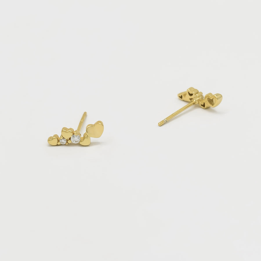 These gold heart stud earrings with sparkling cubic zircon are the perfect blend of elegance and playfulness. Set in a sleek gold finish, these earrings exude refined elegance and fresh sophistication, perfect for both everyday wear and special occasions. 