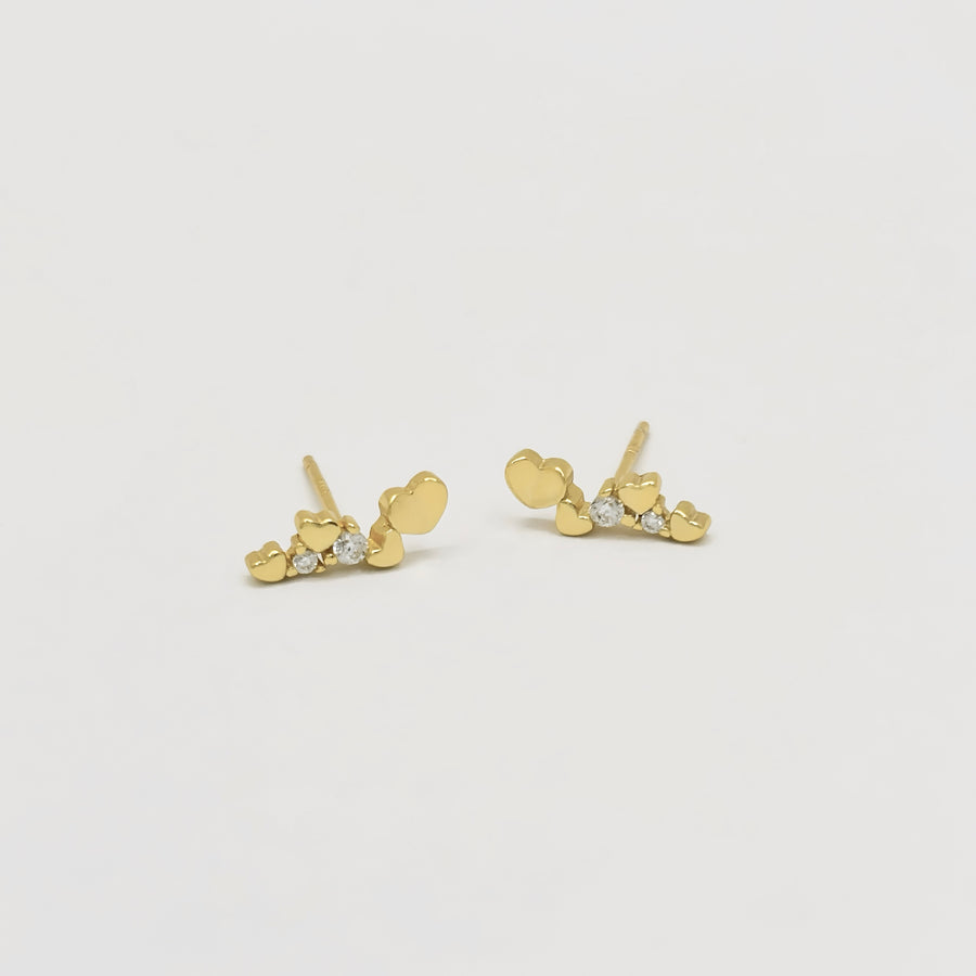 These gold heart stud earrings with sparkling cubic zircon are the perfect blend of elegance and playfulness. Set in a sleek gold finish, these earrings exude refined elegance and fresh sophistication, perfect for both everyday wear and special occasions. 