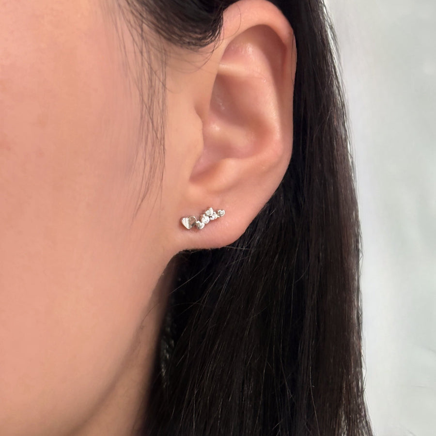 These silver heart stud earrings with sparkling cubic zircon are the perfect blend of elegance and playfulness. Set in a sleek silver finish, these earrings exude refined elegance and fresh sophistication, perfect for both everyday wear and special occasions.