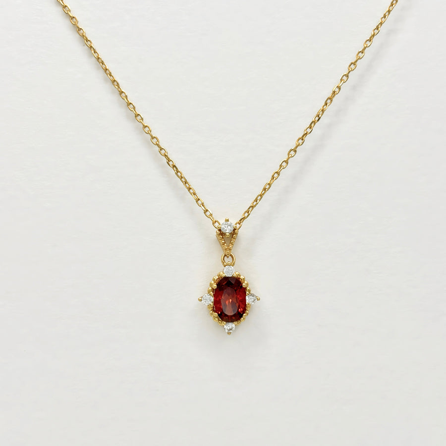 This elegant necklace features a stunning red cubic zircon set in a delicate gold chain. The central gemstone is surrounded by small, sparkling cubic zircon, adding a touch of sophistication and brilliance to the piece. Perfect for special occasions or everyday wear, this necklace combines timeless elegance with modern charm.