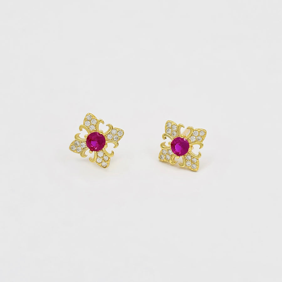 These exquisite earrings feature a central round ruby cubic zircon, surrounded by a delicate gold floral design. The petals are adorned with sparkling cubic zircon, creating a luxurious and elegant look. Perfect for special occasions or adding a touch of elegance to your everyday style, these earrings are a timeless addition to any jewelry collection. 