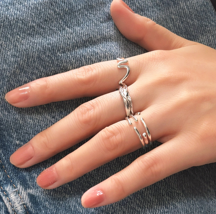 This unique 925 sterling silver ring features a wave-inspired open design, combining modern aesthetics with artistic flair. Adjustable and lightweight, this ring is a versatile accessory that complements any casual or formal look. 