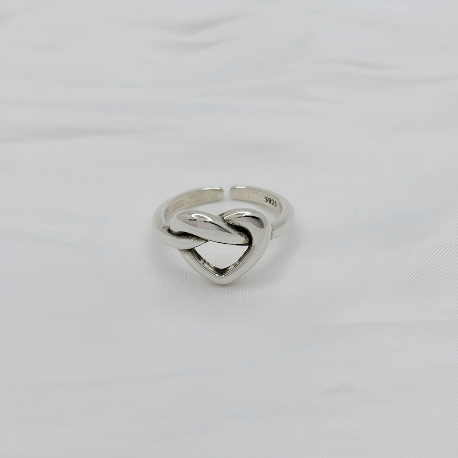 This ring is made of 925 silver and features a heart-shaped design with a punk style. It is perfect for adding a touch of edginess to any outfit. The ring is adjustable and can fit various sizes.