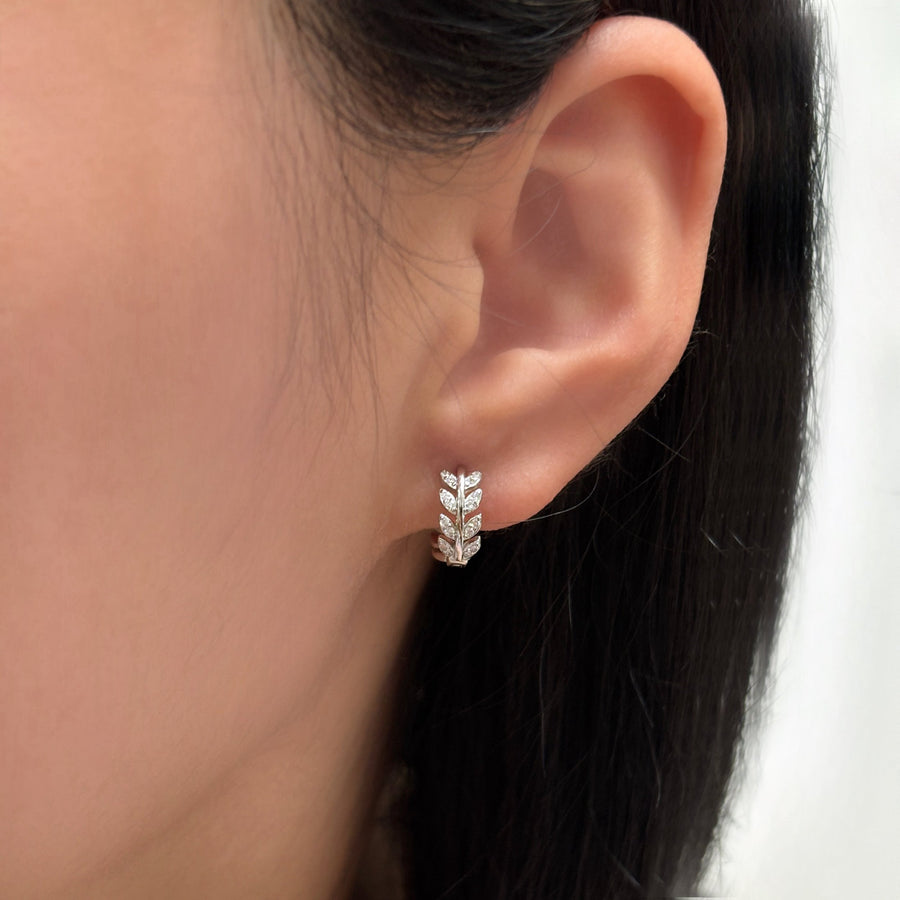 These exquisite silver earrings feature a delicate leaf design adorned with sparkling cubic zircon, adding a touch of nature-inspired elegance. Perfect for both everyday wear and special occasions, they effortlessly elevate your style with a refined and luxurious finish. 