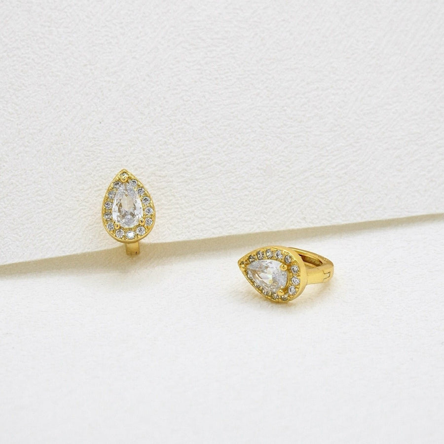 Crafted with elegance in mind, these teardrop-shaped earrings feature a dazzling central cubic zircon surrounded by a halo of shimmering cubic zircon. Perfect for adding a touch of glamour to any outfit