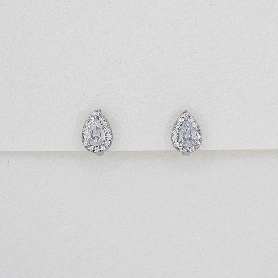 Crafted with elegance in mind, these teardrop-shaped earrings feature a dazzling central cubic zircon surrounded by a halo of shimmering cubic zircon. Perfect for adding a touch of glamour to any outfit