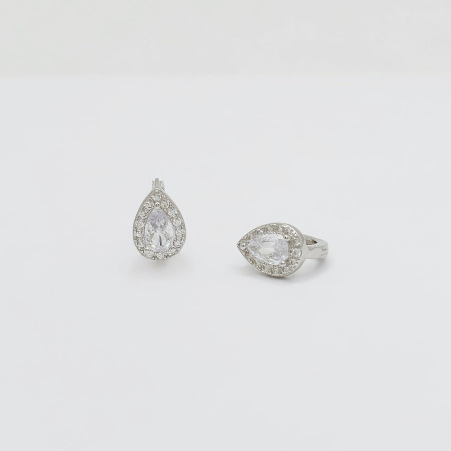 Crafted with elegance in mind, these teardrop-shaped earrings feature a dazzling central cubic zircon surrounded by a halo of shimmering cubic zircon. Perfect for adding a touch of glamour to any outfit