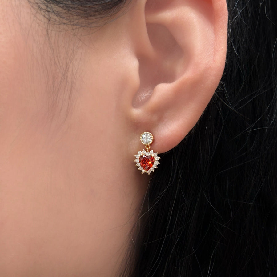 These exquisite 925 silver earrings feature a stunning heart-shaped red cubic zircon, surrounded by a halo of sparkling white cubic zircon, adding a touch of elegance and romance to any outfit. Perfect for any occasions.