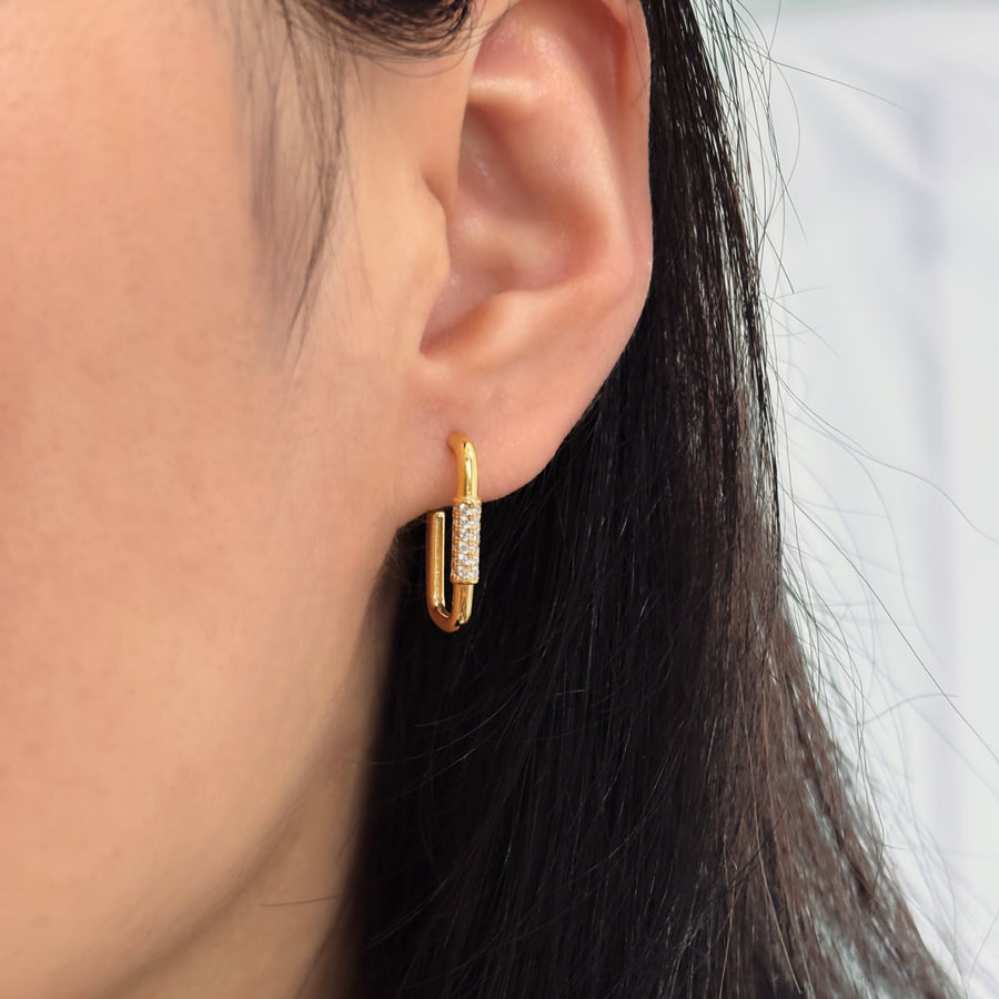 These elegant gold earrings feature a unique U-shaped design adorned with sparkling diamonds, adding a touch of sophistication to any outfit. Perfect for both casual and formal occasions, these earrings are crafted to provide a timeless and luxurious appeal.