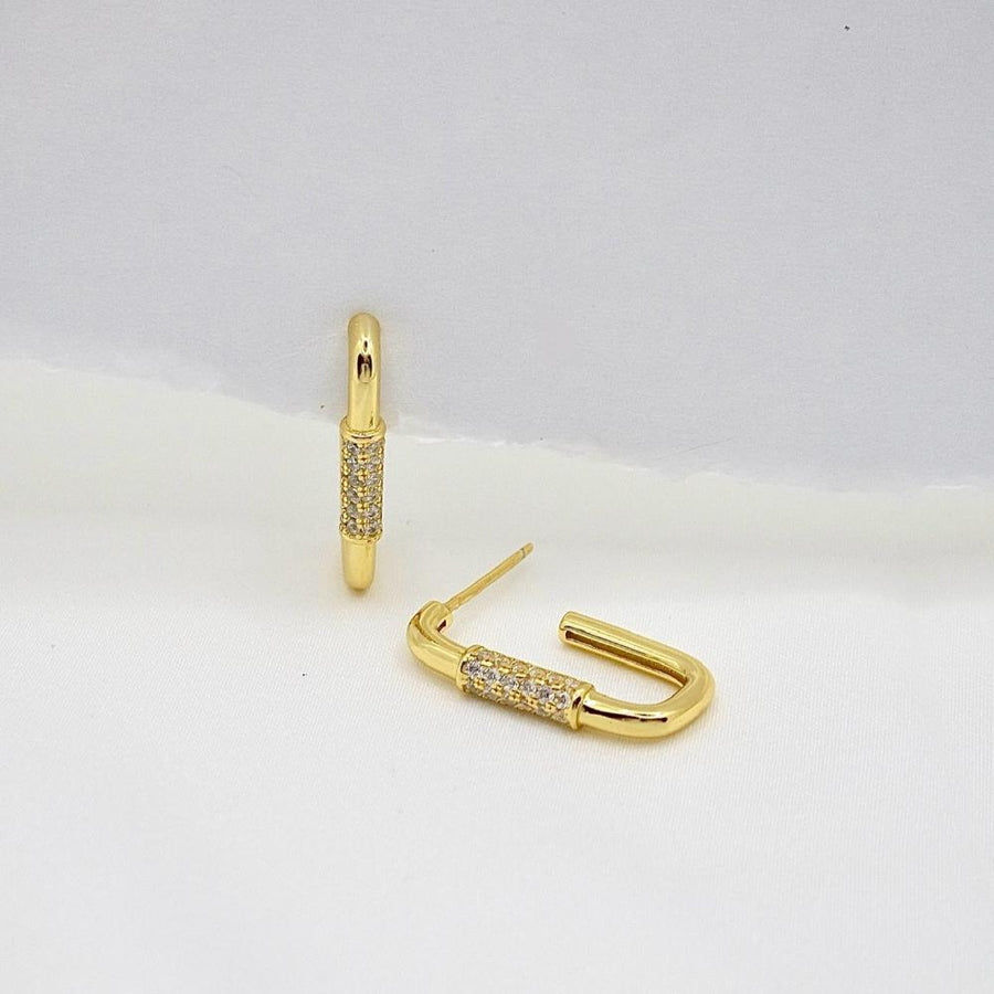 These elegant gold earrings feature a unique U-shaped design adorned with sparkling diamonds, adding a touch of sophistication to any outfit. Perfect for both casual and formal occasions, these earrings are crafted to provide a timeless and luxurious appeal.