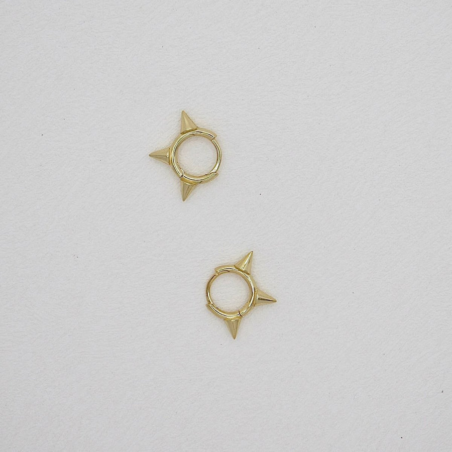 Featuring sleek gold finishes and edgy spike details, these earrings are the perfect statement piece to elevate your style with confidence and flair. perfect for both everyday wear and special occasions.