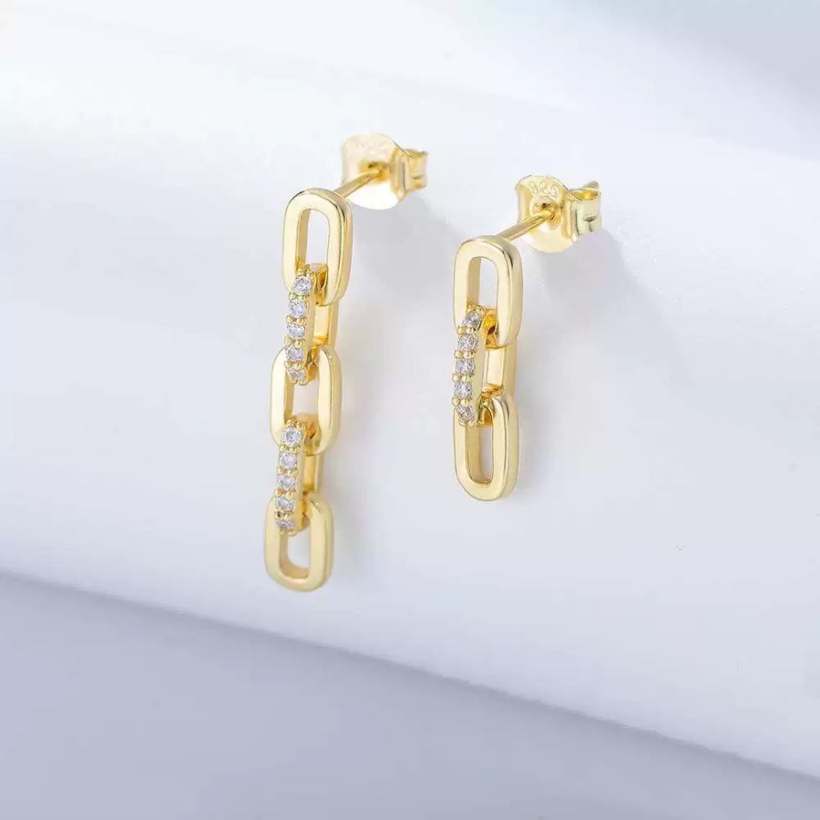 The earrings showcase a refined chain-link design adorned with shimmering set cubic zircon. These graceful, modern earrings combine timeless sophistication with a touch of sparkle, perfect for elevating both everyday and evening looks.