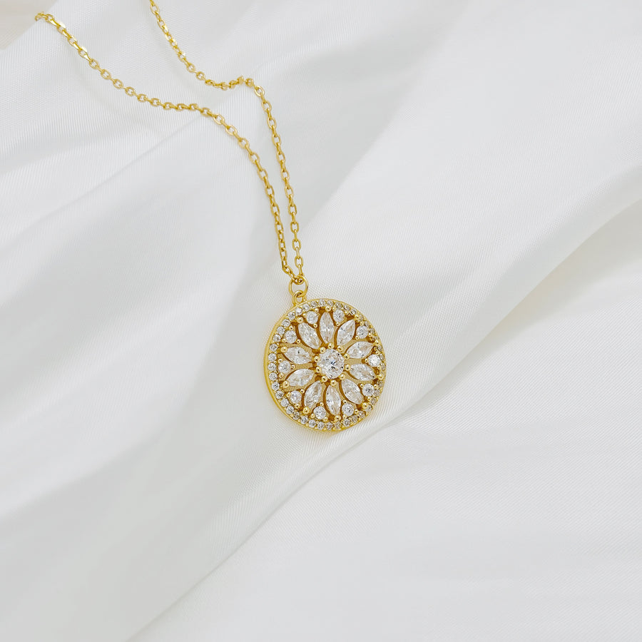 Handcrafted in gold vermeil. This stunning gold necklace features a circular pendant with a floral design, adorned with sparkling cubic zircon that add elegance and brilliance to any look.