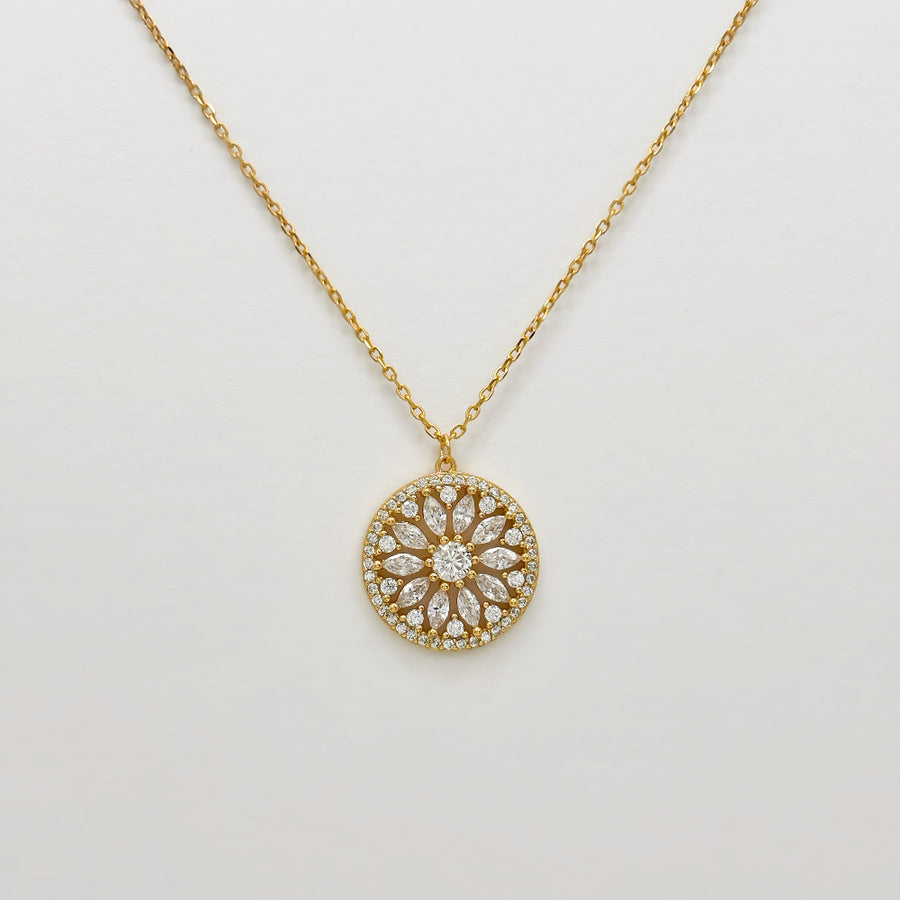 Handcrafted in gold vermeil. This stunning gold necklace features a circular pendant with a floral design, adorned with sparkling cubic zircon that add elegance and brilliance to any look.