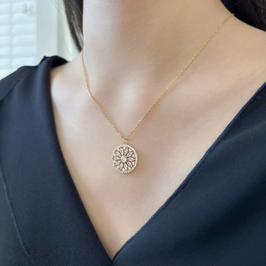 Handcrafted in gold vermeil. This stunning gold necklace features a circular pendant with a floral design, adorned with sparkling cubic zircon that add elegance and brilliance to any look.