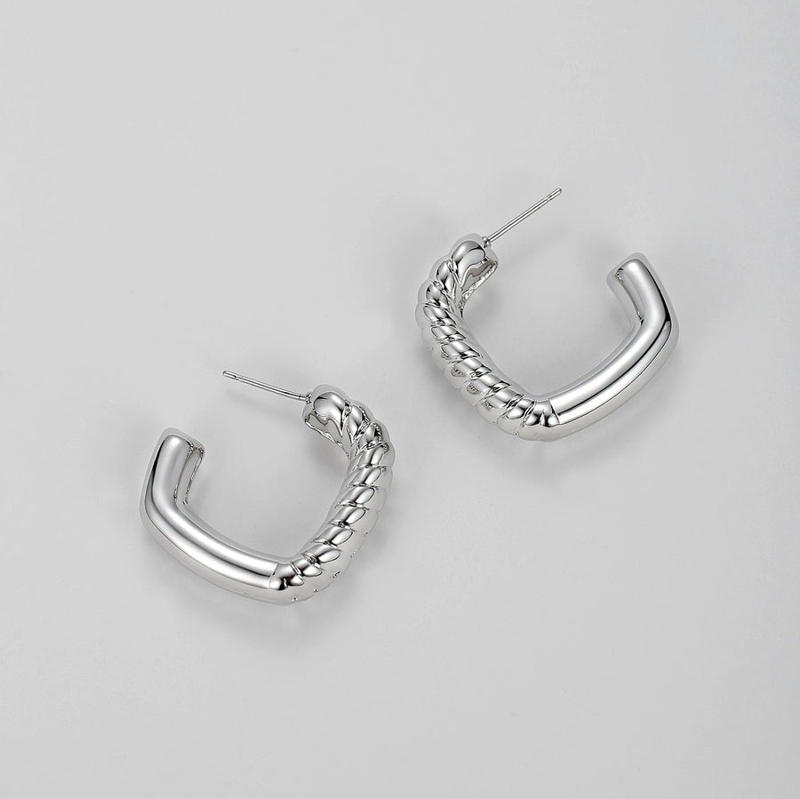 Redefine modern sophistication with our twisted elegance hoop earrings. Featuring a sleek, gold-tone finish and a unique twisted rope design, these earrings add a bold yet refined touch to any outfit. Their semi-open hoop style offers a contemporary spin on the classic hoop, making them a statement piece perfect for both casual and formal occasions.