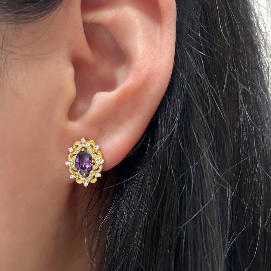 Silver Stud Earrings. Elevate your elegance with these dazzling gold earrings, featuring vibrant purple gemstones surrounded by sparkling cubic zirconia. Perfect for adding a royal touch to your look, whether for everyday wear or special occasions.