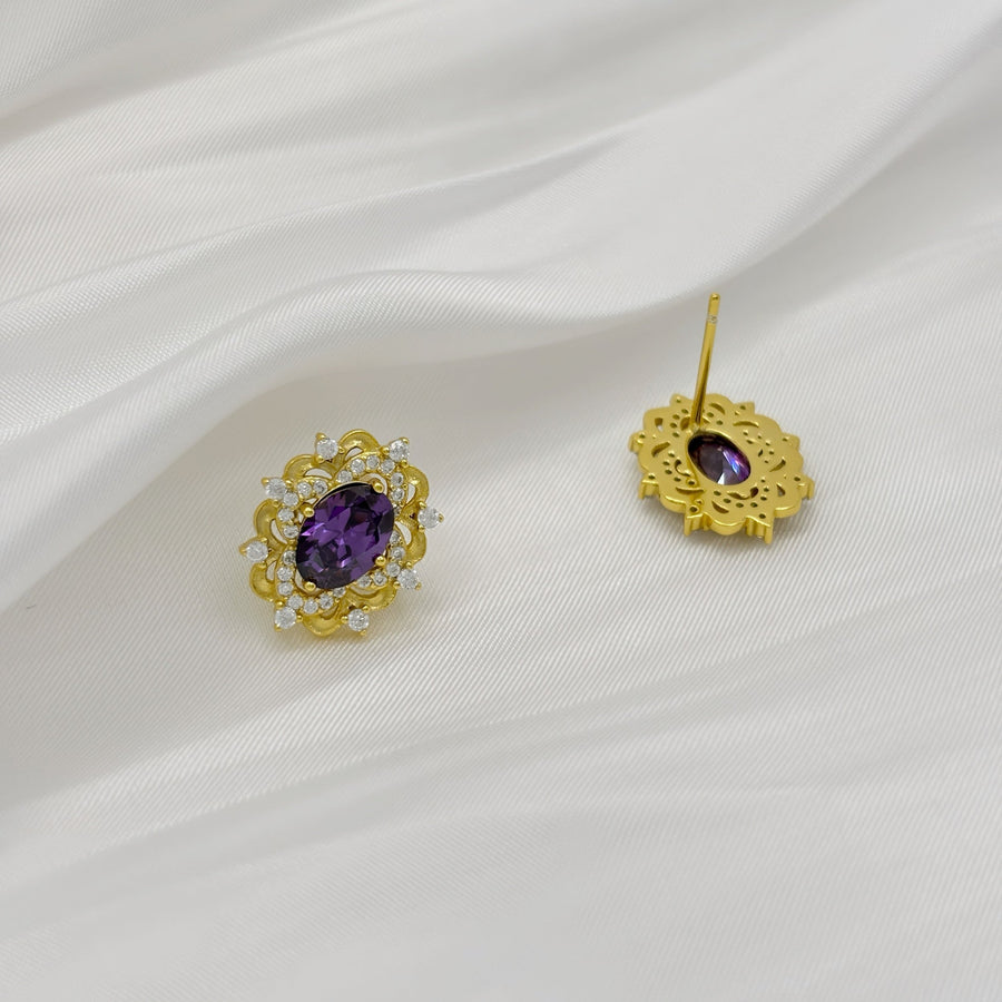 Silver Stud Earrings. Elevate your elegance with these dazzling gold earrings, featuring vibrant purple gemstones surrounded by sparkling cubic zirconia. Perfect for adding a royal touch to your look, whether for everyday wear or special occasions.