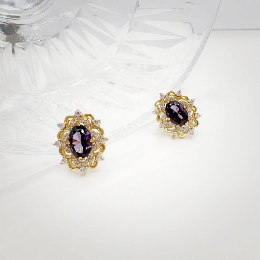 Silver Stud Earrings. Elevate your elegance with these dazzling gold earrings, featuring vibrant purple gemstones surrounded by sparkling cubic zirconia. Perfect for adding a royal touch to your look, whether for everyday wear or special occasions.