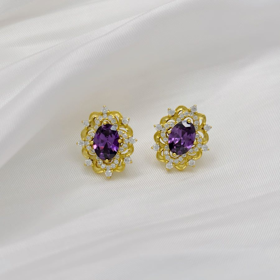 Silver Stud Earrings. Elevate your elegance with these dazzling gold earrings, featuring vibrant purple gemstones surrounded by sparkling cubic zirconia. Perfect for adding a royal touch to your look, whether for everyday wear or special occasions.