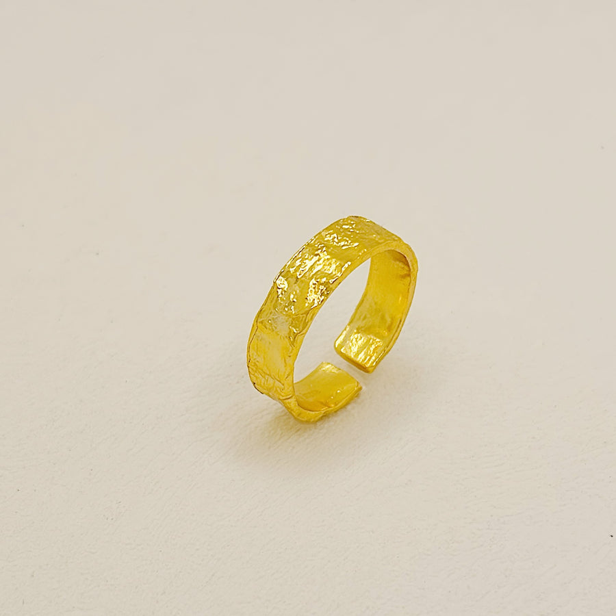 This Classic Gold Flat Band Ring showcases a refined hammered finish, adding a unique artisanal touch to a minimalist design. Designed for versatility, its open-end design ensures a perfect fit for any finger size, making it a staple in any jewelry collection.