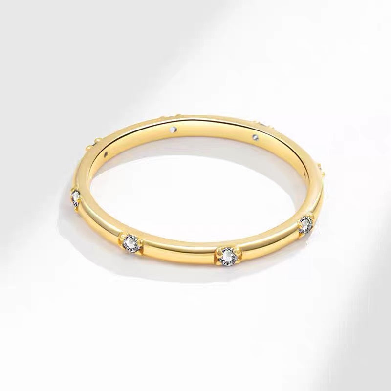 This stunning gold ring features a sleek, polished band adorned with evenly spaced, sparkling diamonds, adding a touch of sophistication and luxury. 925 silver