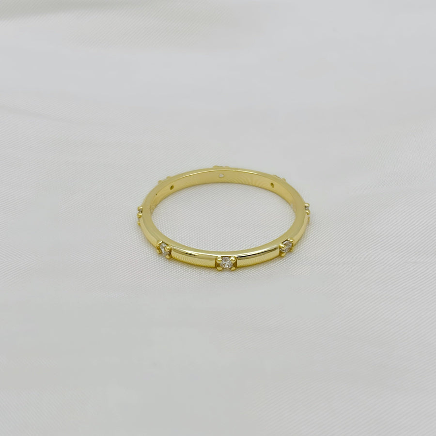 This stunning gold ring features a sleek, polished band adorned with evenly spaced, sparkling diamonds, adding a touch of sophistication and luxury. 925 silver