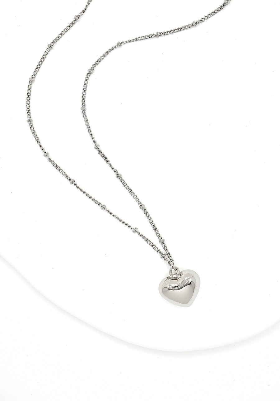 This silver heart-shaped pendant necklace is a timeless and elegant accessory. Crafted from pure sterling silver, it exudes a classic and understated charm. Perfect for any occasion, it adds a touch of sophistication to any outfit. 