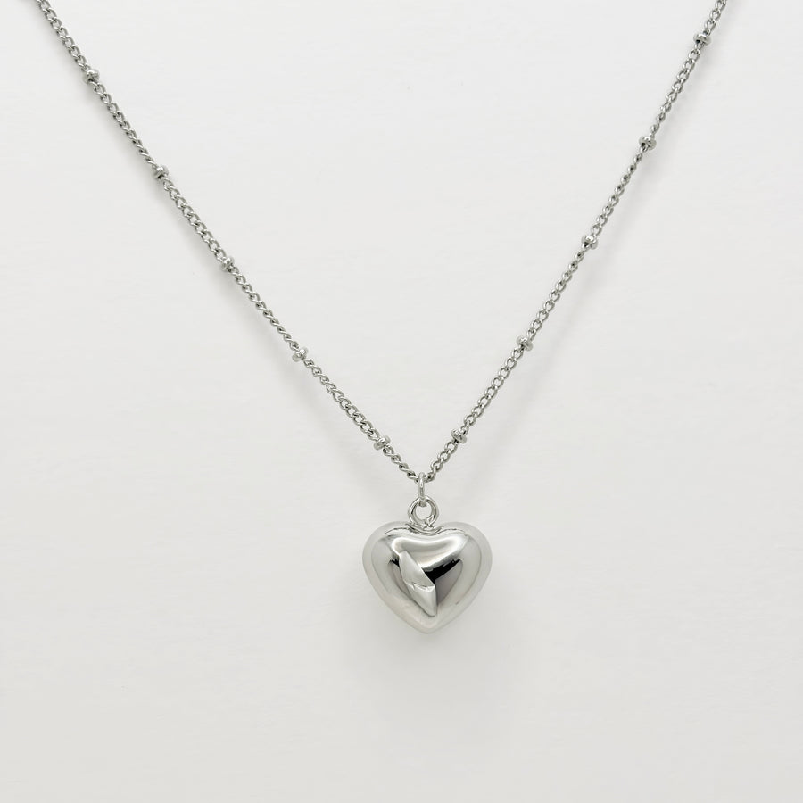 This silver heart-shaped pendant necklace is a timeless and elegant accessory. Crafted from pure sterling silver, it exudes a classic and understated charm. Perfect for any occasion, it adds a touch of sophistication to any outfit. 