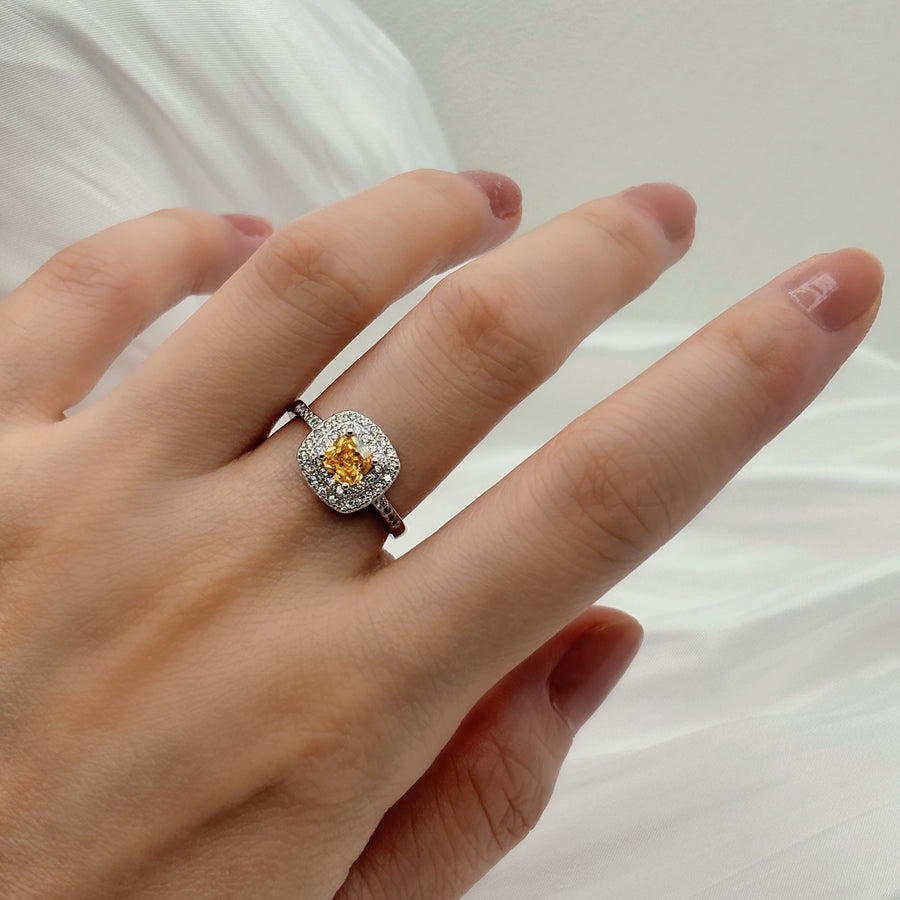 This is a stunning  yellow cubic zircon diamond ring that sparkles with elegance and romance. The center stone is a exquisite yellow cubic zircon, surrounded two halos of brilliant white cubic zircons.