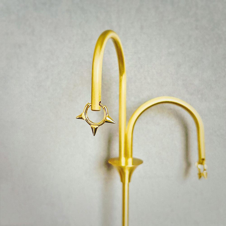 Featuring sleek gold finishes and edgy spike details, these earrings are the perfect statement piece to elevate your style with confidence and flair. perfect for both everyday wear and special occasions.