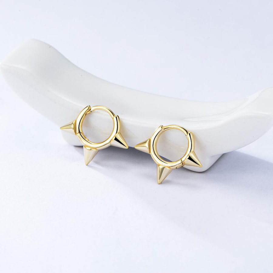 Featuring sleek gold finishes and edgy spike details, these earrings are the perfect statement piece to elevate your style with confidence and flair. perfect for both everyday wear and special occasions.